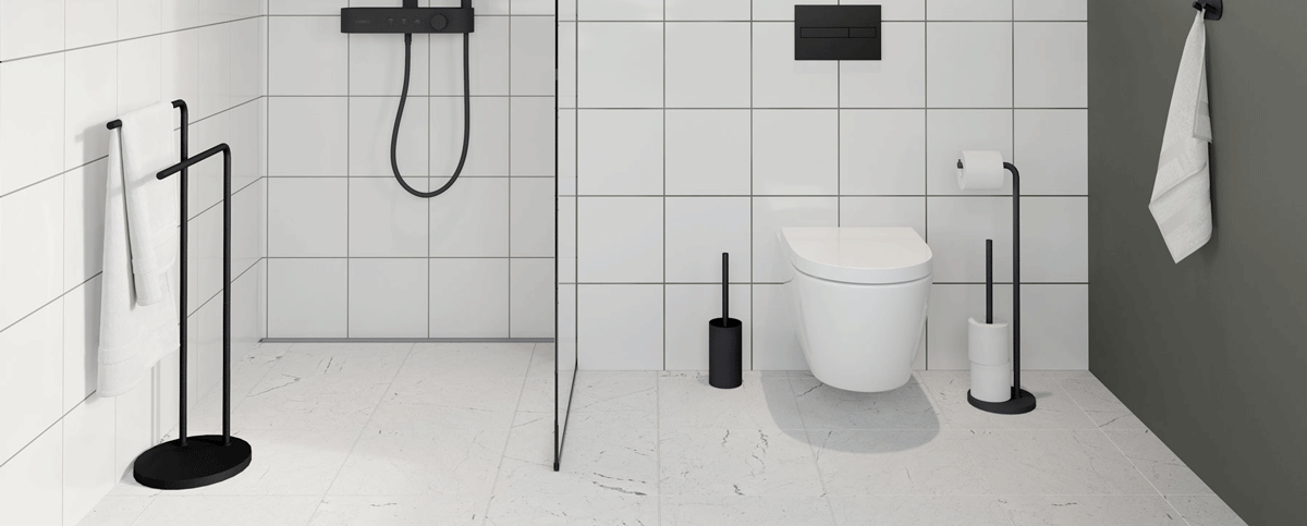 Matte black stand-alone products in a green bathroom with white tiles
